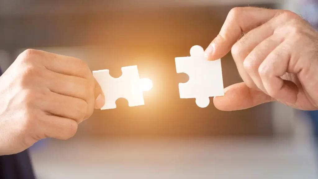 duas peças de quebra-cabeça sendo conectadas