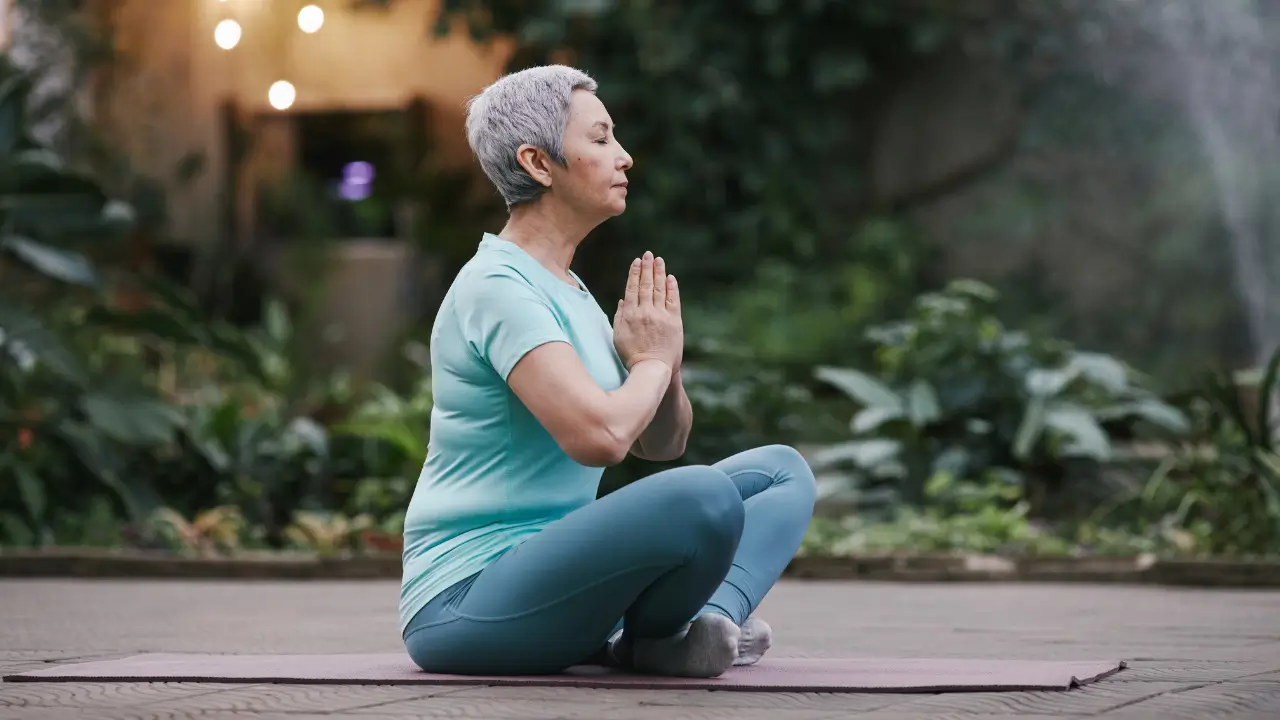 Mulher na menopausa praticando meditação kundalini para despertar energia vital